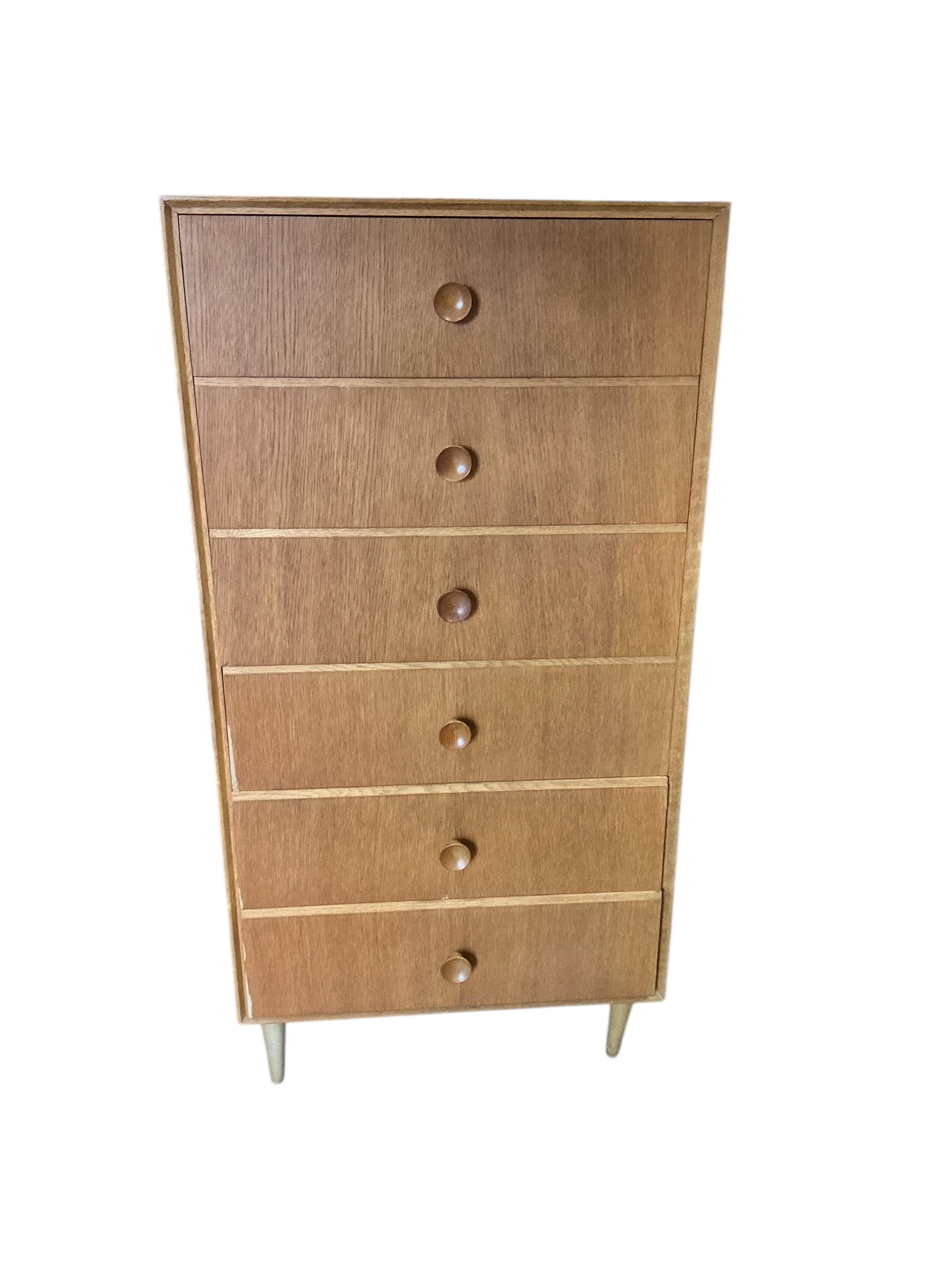 A mid century oak six drawer chest, width 61cm, depth 46cm, height 124cm